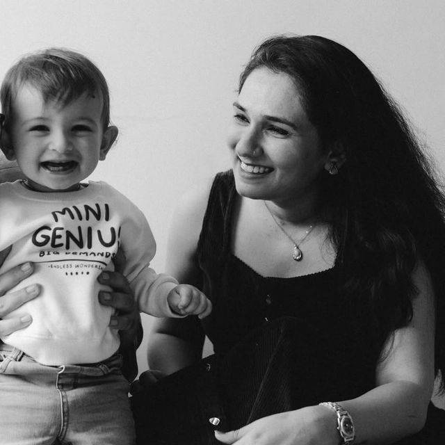 A smiling woman looking at her child